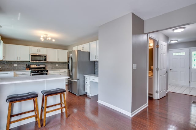 1818 Olde Mill Rd, Plainfield, IL 60586 - kitchen featuring appliances with stainless steel finishes, decorative backsplash, dark wood-style floors, and light countertops