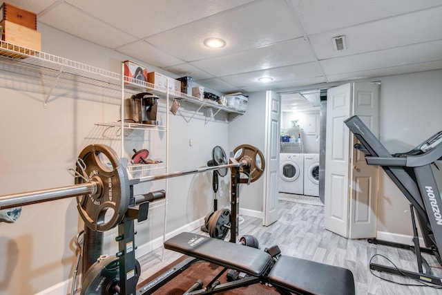 1818 Olde Mill Rd, Plainfield, IL 60586 - exercise room featuring washer and dryer, a paneled ceiling, and wood finished floors
