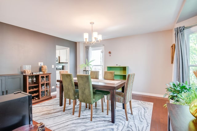 1818 Olde Mill Rd, Plainfield, IL 60586 - dining area featuring a chandelier, plenty of natural light, and light wood-style flooring
