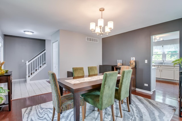 1818 Olde Mill Rd, Plainfield, IL 60586 - dining room with a chandelier, light wood-style flooring, and stairs