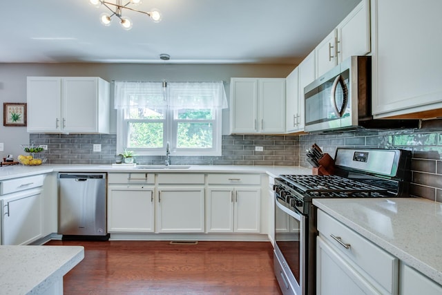 1818 Olde Mill Rd, Plainfield, IL 60586 - kitchen with stainless steel appliances, backsplash, white cabinetry, and dark wood finished floors