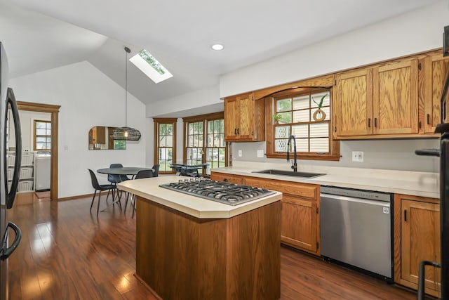 1091 Danforth Dr, Batavia, IL 60510 - kitchen featuring appliances with stainless steel finishes, a skylight, light countertops, vaulted ceiling, and brown cabinetry