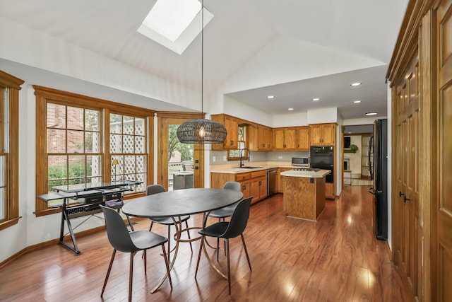 1091 Danforth Dr, Batavia, IL 60510 - dining area featuring a skylight, dark wood-style flooring, plenty of natural light, recessed lighting, and high vaulted ceiling