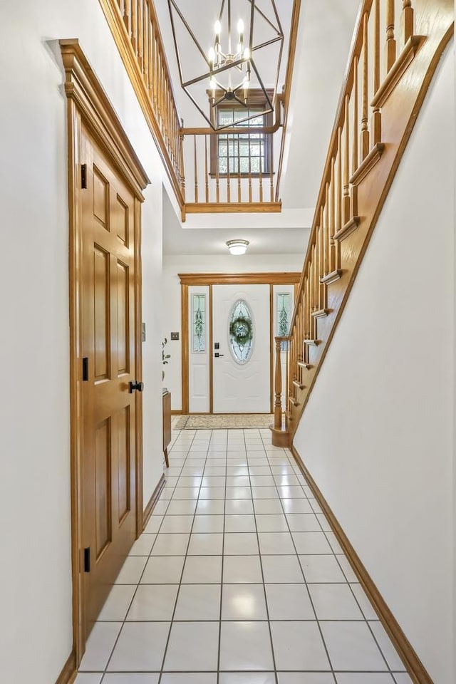 1091 Danforth Dr, Batavia, IL 60510 - entrance foyer featuring a towering ceiling, a chandelier, stairs, and light tile patterned floors