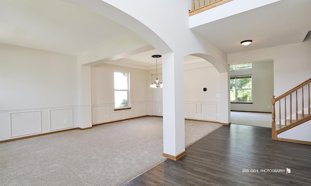 1305 Lilac Ln, Harvard, IL 60033 - entrance foyer featuring healthy amount of natural light, a decorative wall, wood finished floors, a chandelier, and stairs