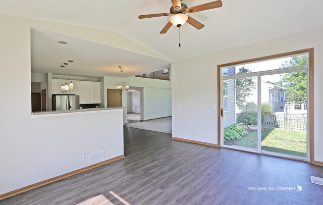 1305 Lilac Ln, Harvard, IL 60033 - unfurnished living room with dark wood-style floors, lofted ceiling, a ceiling fan, and a chandelier