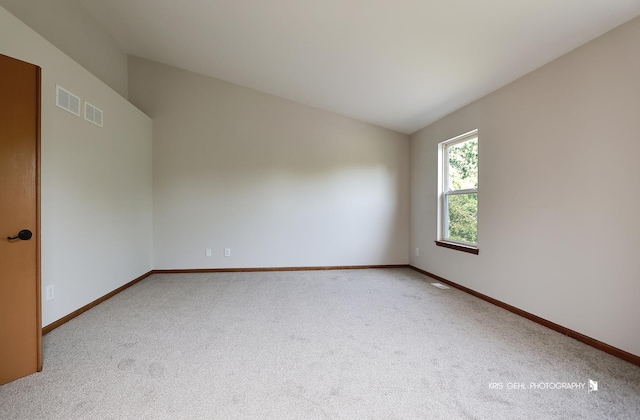 1305 Lilac Ln, Harvard, IL 60033 - carpeted spare room featuring vaulted ceiling and baseboards