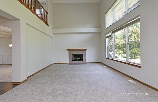 1305 Lilac Ln, Harvard, IL 60033 - unfurnished living room with carpet, a high ceiling, and a fireplace