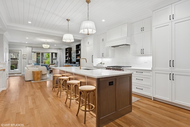 823 W George St Unit 1, Chicago, IL 60657 - kitchen with light wood finished floors, open floor plan, white cabinetry, light countertops, and recessed lighting
