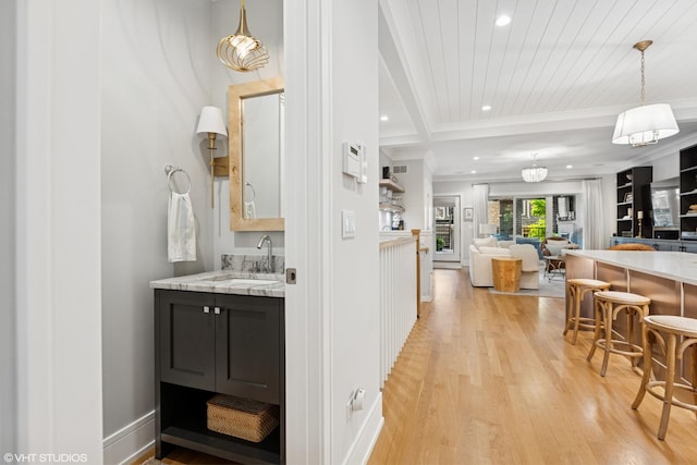 823 W George St Unit 1, Chicago, IL 60657 - bar with light wood-style flooring, recessed lighting, ornamental molding, and hanging light fixtures