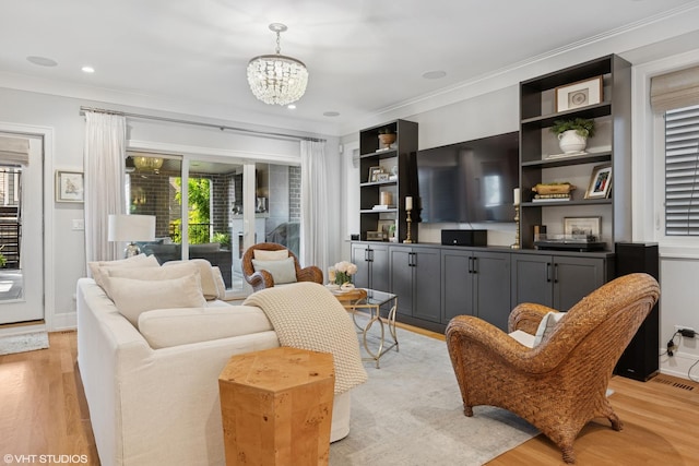 823 W George St Unit 1, Chicago, IL 60657 - living room with light wood-style floors, a chandelier, crown molding, and recessed lighting