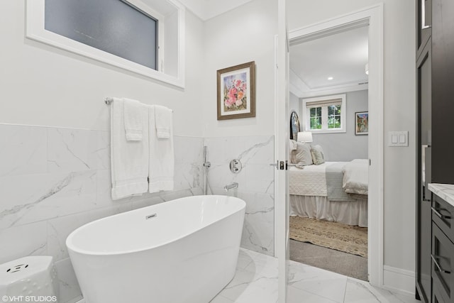 823 W George St Unit 1, Chicago, IL 60657 - ensuite bathroom featuring marble tiled flooring, a soaking tub, tile walls, vanity, and wainscoting