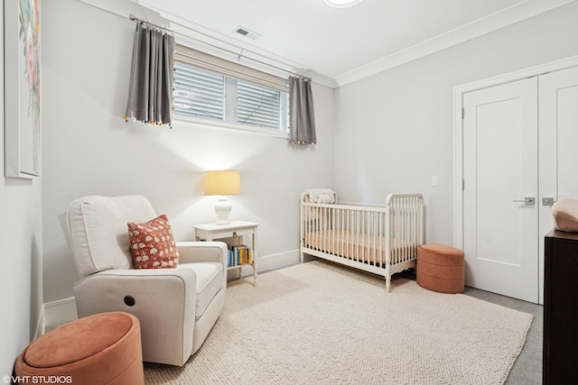 823 W George St Unit 1, Chicago, IL 60657 - carpeted bedroom with a crib, ornamental molding, and a closet