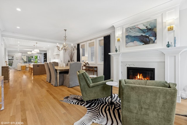 823 W George St Unit 1, Chicago, IL 60657 - living area featuring a chandelier, light wood-type flooring, a premium fireplace, crown molding, and recessed lighting