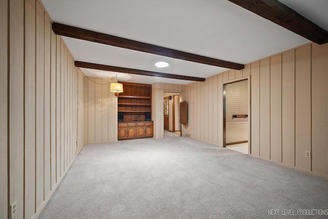 2050 Alschuler Dr, Aurora, IL 60506 - unfurnished living room featuring light carpet, beam ceiling, and wooden walls