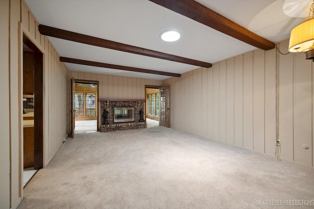 2050 Alschuler Dr, Aurora, IL 60506 - unfurnished living room with beamed ceiling, carpet floors, a fireplace, and wood walls