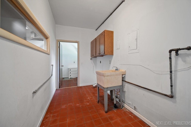 2050 Alschuler Dr, Aurora, IL 60506 - laundry room with cabinet space, dark tile patterned flooring, and electric panel