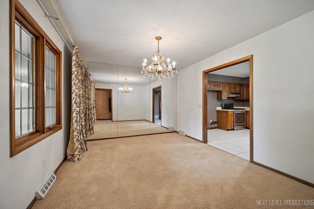 2050 Alschuler Dr, Aurora, IL 60506 - spare room featuring a chandelier, light carpet, and light tile patterned floors