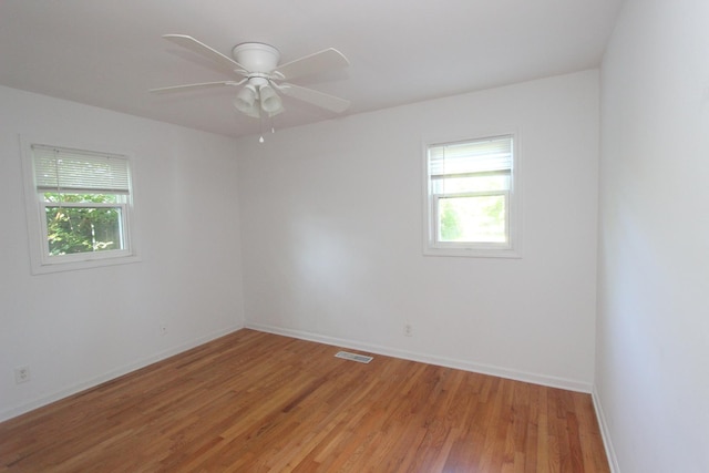 1521 Adams St, Lake In The Hills, IL 60156 - empty room with plenty of natural light, light wood finished floors, and ceiling fan