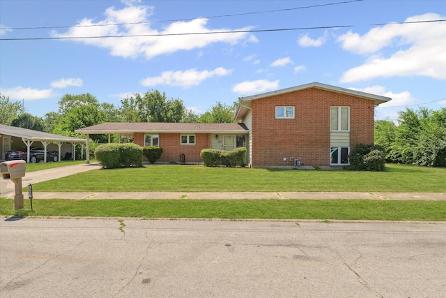 1565 S Pointe Dr, Rantoul, IL 61866 - split level home with brick siding, a front yard, and concrete driveway