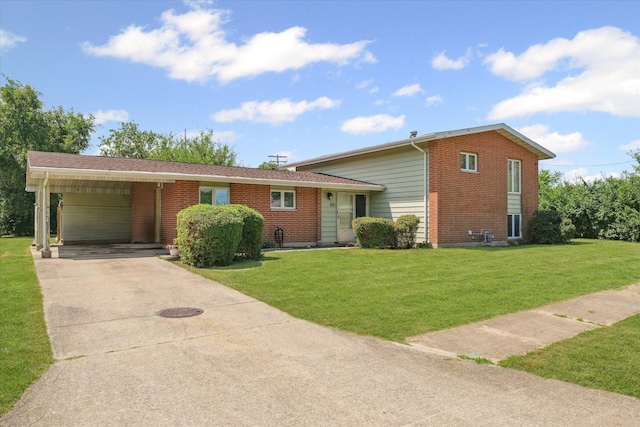 1565 S Pointe Dr, Rantoul, IL 61866 - split level home with concrete driveway, a front lawn, an attached carport, and brick siding