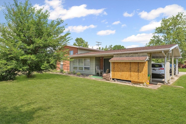 1565 S Pointe Dr, Rantoul, IL 61866 - rear view of house with a yard and a carport