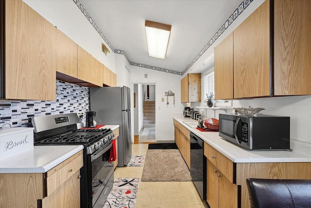 1565 S Pointe Dr, Rantoul, IL 61866 - kitchen featuring black appliances, backsplash, and light countertops