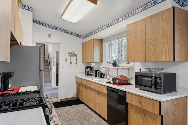 1565 S Pointe Dr, Rantoul, IL 61866 - kitchen with black dishwasher, freestanding refrigerator, light countertops, and lofted ceiling