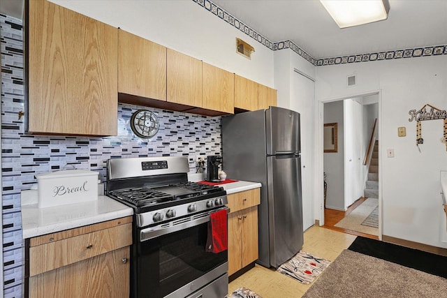 1565 S Pointe Dr, Rantoul, IL 61866 - kitchen featuring stainless steel appliances, tasteful backsplash, light countertops, light wood finished floors, and light brown cabinetry