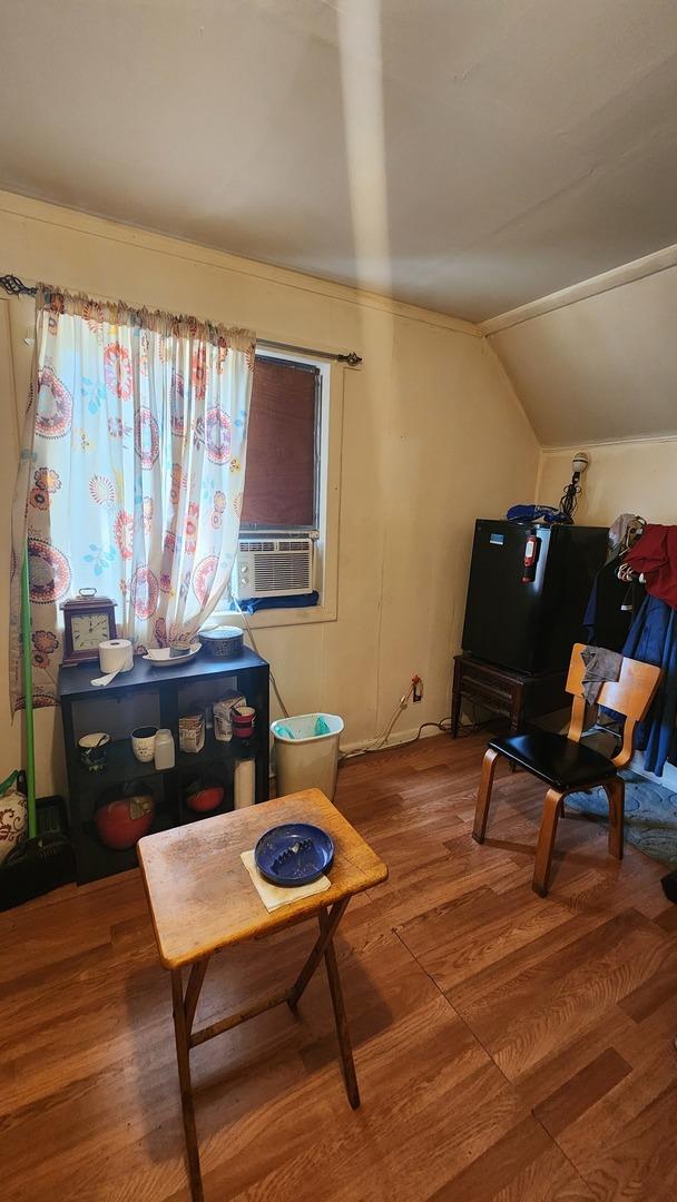 5234 W 25th Pl, Cicero, IL 60804 - sitting room with wood finished floors, cooling unit, and lofted ceiling