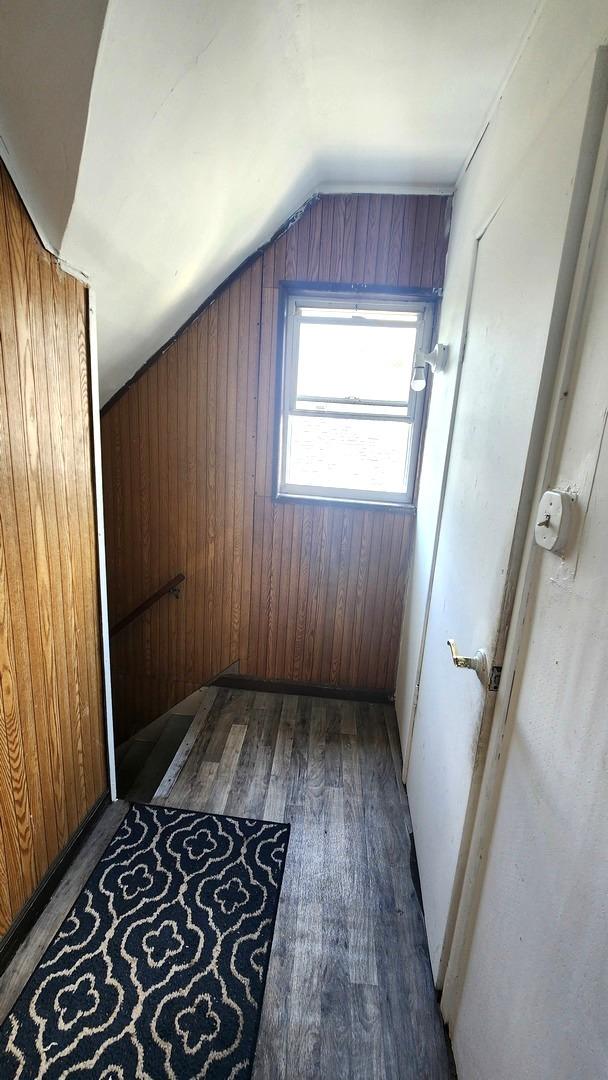 5234 W 25th Pl, Cicero, IL 60804 - bonus room with vaulted ceiling, wooden walls, and wood finished floors
