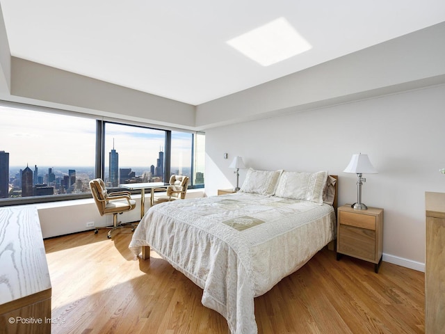 175 E Delaware Pl Unit 8808, Chicago, IL 60611 - bedroom with a view of skyline and wood finished floors