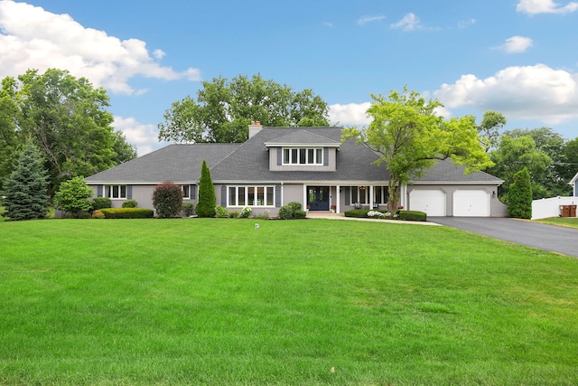 22W672 Elmwood Dr, Glen Ellyn, IL 60137 - traditional-style home featuring asphalt driveway, a garage, a front lawn, and a chimney