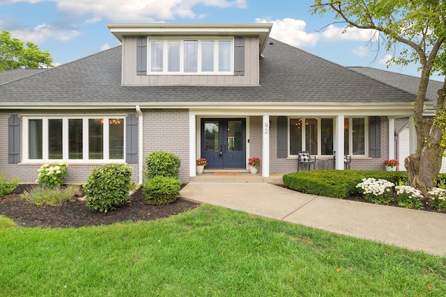 22W672 Elmwood Dr, Glen Ellyn, IL 60137 - view of front of home with brick siding, a front lawn, french doors, and board and batten siding