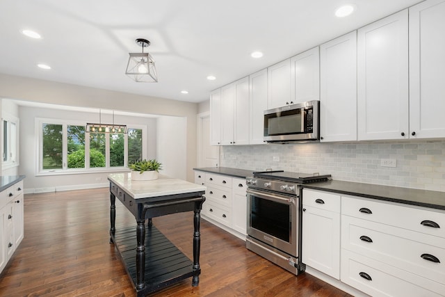 22W672 Elmwood Dr, Glen Ellyn, IL 60137 - kitchen featuring stainless steel appliances, dark countertops, tasteful backsplash, and recessed lighting