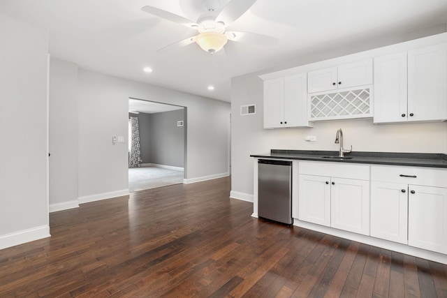 22W672 Elmwood Dr, Glen Ellyn, IL 60137 - kitchen with dark wood-type flooring, dark countertops, a ceiling fan, stainless steel dishwasher, and white cabinetry