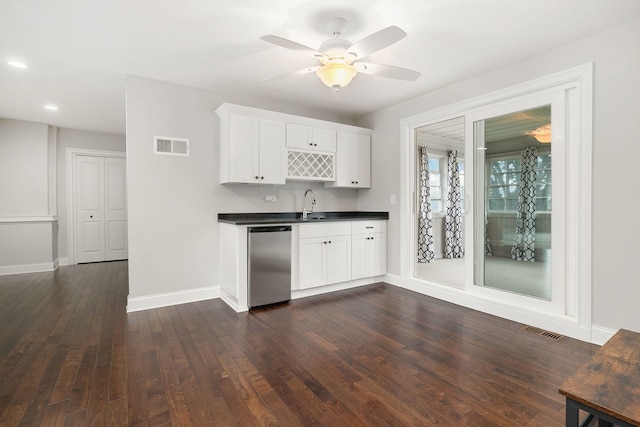 22W672 Elmwood Dr, Glen Ellyn, IL 60137 - kitchen with stainless steel dishwasher, dark wood-type flooring, dark countertops, white cabinetry, and a ceiling fan