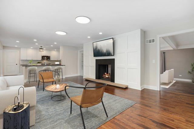 22W672 Elmwood Dr, Glen Ellyn, IL 60137 - living room with wood finished floors, recessed lighting, and a warm lit fireplace