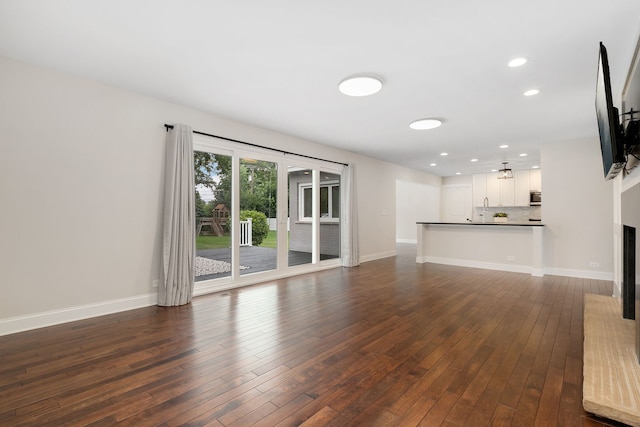 22W672 Elmwood Dr, Glen Ellyn, IL 60137 - unfurnished living room with dark wood-style floors, recessed lighting, and a fireplace