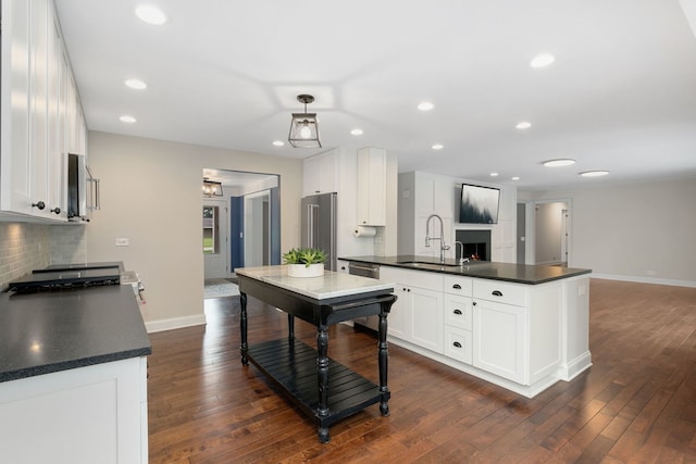 22W672 Elmwood Dr, Glen Ellyn, IL 60137 - kitchen with dark countertops, dark wood-type flooring, appliances with stainless steel finishes, and recessed lighting