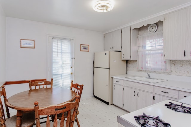 3628 N Oconto Ave, Chicago, IL 60634 - kitchen featuring freestanding refrigerator, plenty of natural light, and light countertops