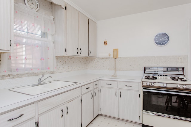 3628 N Oconto Ave, Chicago, IL 60634 - kitchen featuring white range with gas cooktop, light countertops, and light floors