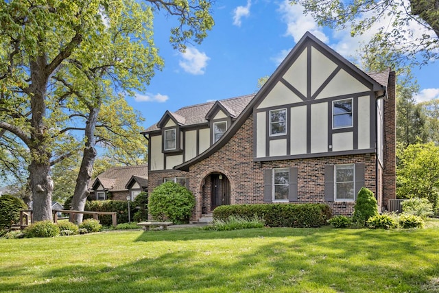 11280 James Ct, Genoa, IL 60135 - tudor home with brick siding, stucco siding, and a front yard