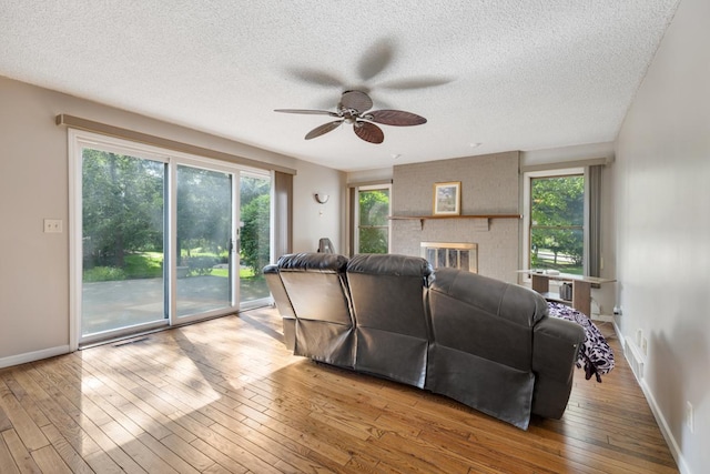 11280 James Ct, Genoa, IL 60135 - living area with a ceiling fan, plenty of natural light, a textured ceiling, and wood-type flooring