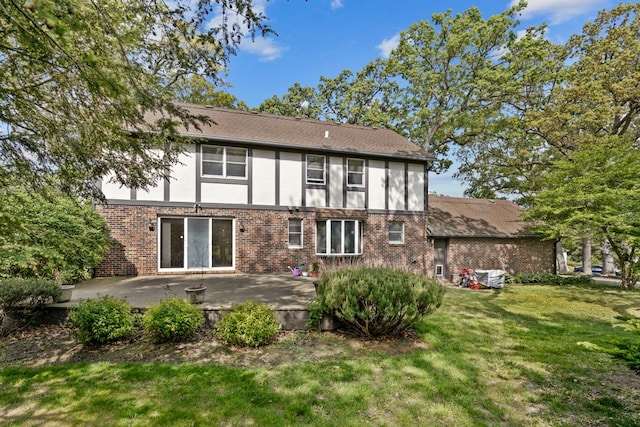 11280 James Ct, Genoa, IL 60135 - rear view of property with a lawn, brick siding, a patio area, and stucco siding