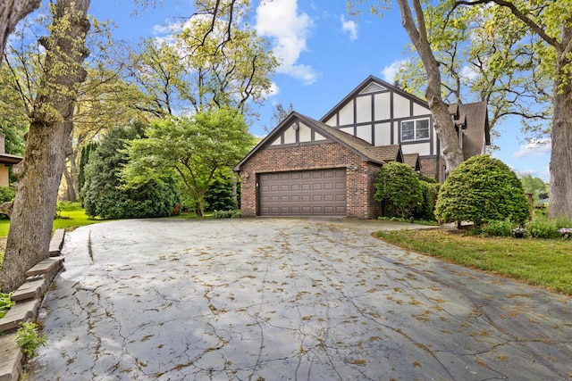 11280 James Ct, Genoa, IL 60135 - view of front of house with brick siding, an attached garage, and driveway