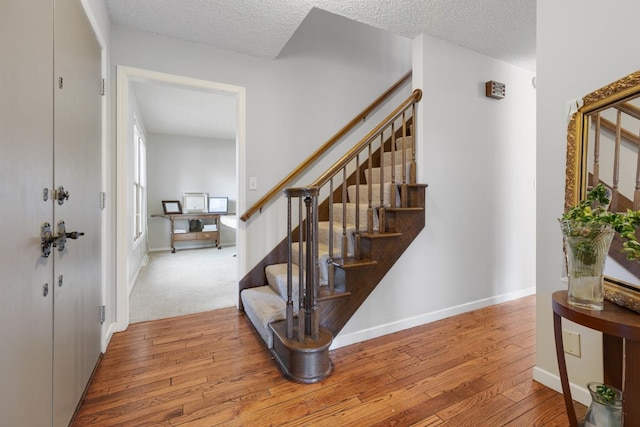 11280 James Ct, Genoa, IL 60135 - entryway featuring hardwood / wood-style flooring, a textured ceiling, and stairway