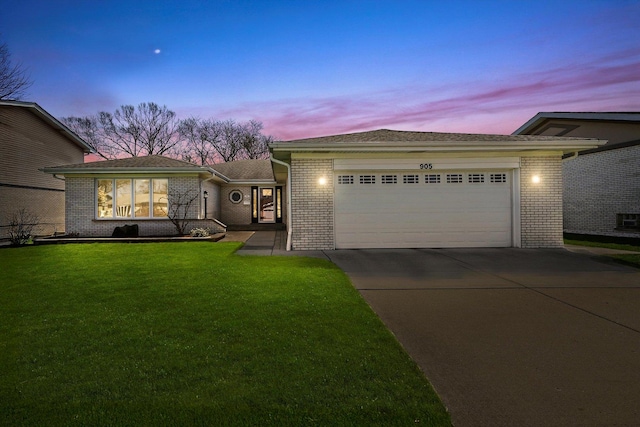 905 W Palm Dr, Mount Prospect, IL 60056 - view of front of home with brick siding, concrete driveway, a front lawn, and an attached garage