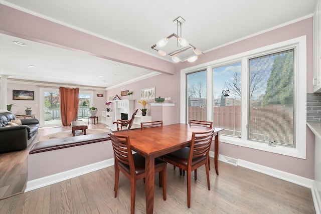 905 W Palm Dr, Mount Prospect, IL 60056 - dining area featuring light wood-style floors and ornamental molding