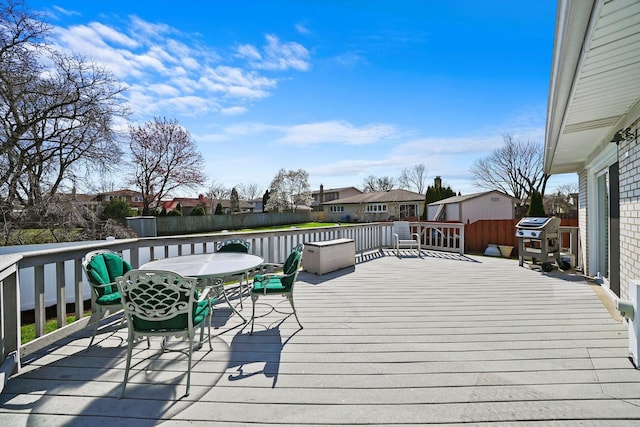 905 W Palm Dr, Mount Prospect, IL 60056 - wooden terrace featuring a residential view, outdoor dining area, a fenced backyard, and a grill